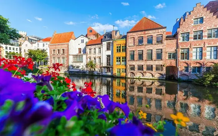 Beautiful European homes and colorful flowers along the river's edge