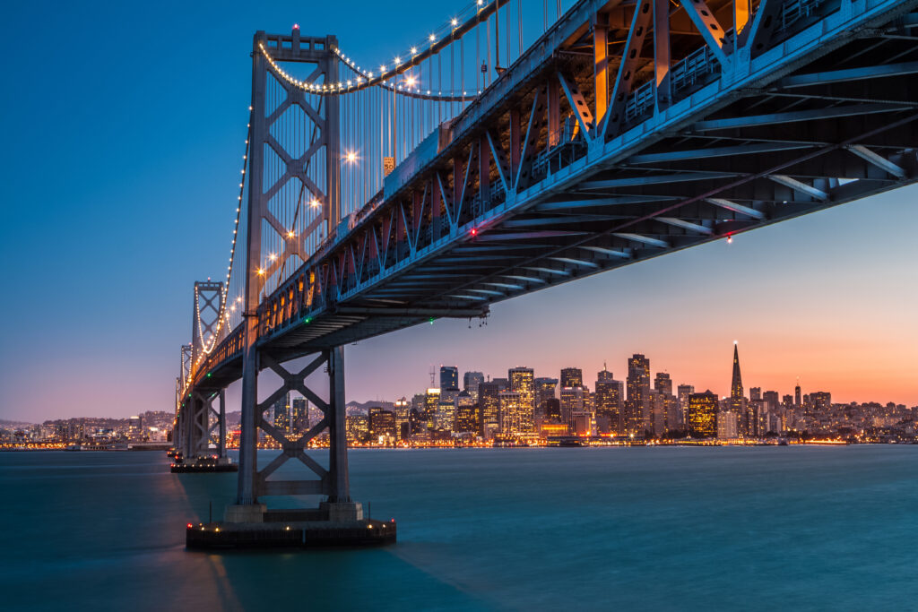 San Francisco skyline framed by the Bay Bridge at sunset